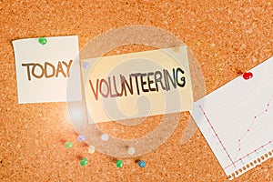 Handwriting text writing Volunteering. Concept meaning Provide services for no financial gain Willingly Oblige Corkboard