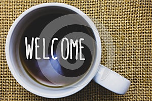 Handwriting text writing Welcome. Concept meaning Warm salutation acknowledgement for someone amiable loved thanked Mug coffee tho photo
