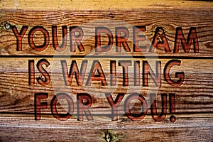 Handwriting text Your Dream Is Waiting For You. Concept meaning Goal Objective Intention Target Yearning Plan Wooden background vi