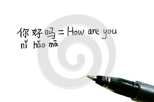 Handwritten Chinese characters with Pinyin of "How Are You" and its English translation with a pen