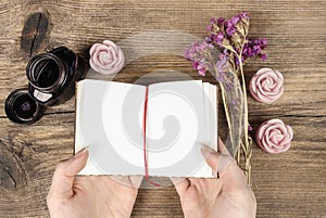 Handwritten diary: woman holding hardcover notebook