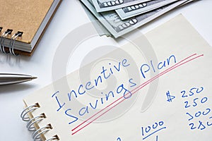 Handwritten Incentive savings plan in the notepad. photo