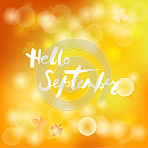 Handwritten lettering Hello September isolated on yellow background.