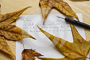 Handwritten love letter with autumn leaves in background