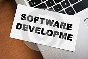 Handwritten note reading software developme placed on a laptop keyboard, symbolizing coding, technology, and the softwar