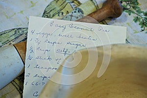 Handwritten pie recipe with dishtowel and antique mortar pestle