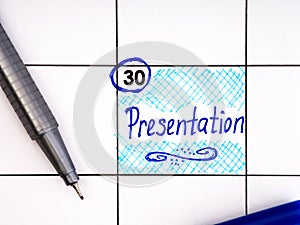 Handwritten reminder Presentation in the calendar with a blue pen