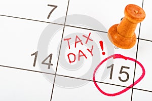 Handwritten Tax day for reminde apointment with wooden pin