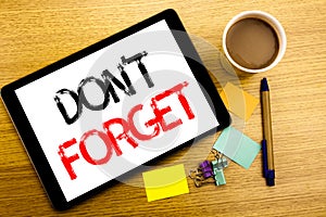 Handwritten text caption showing Do Not Forget. Business concept writing for Don t memory Remider Written on tablet laptop, wooden