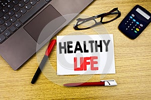 Handwritten text caption showing Healthy Life. Business concept writing for Good Health Food written on paper, wooden background i
