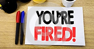 Handwritten text caption showing You Are Fired. Business concept writing for Unemployed or Discharge written on sticky note with c