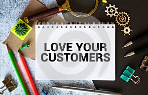 Handwritten text Love Your Customers as business concept image
