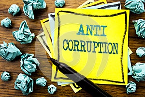 Handwritten text showing Anti Corruption. Business concept for Bribery Corrupt Text Written on sticky note paper, wooden backgroun