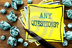 Handwritten text showing Any Questions. Business concept for Answer Help Question Written on sticky note paper, wooden background