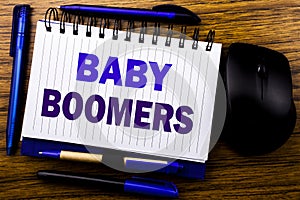 Handwritten text showing Baby Boomers. Business concept for Demographic Generation written on notebook book note paper on the wood