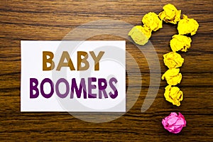 Handwritten text showing Baby Boomers. Business concept for Demographic Generation Written on sticky note paper, wooden background