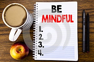 Handwritten text showing Be Mindful. Business concept for Mindfulness Healthy Spirit written on notepad note paper on the wood str