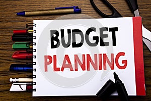 Handwritten text showing Budget Planning. Business concept for Financial Budgeting Written on notebook, wooden background with off