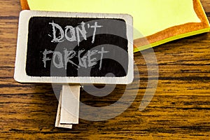 Handwritten text showing Do Not Forget. Business concept for Don t memory Remider written on announcement board on the wooden wood