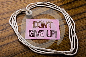 Handwritten text showing Don t Give Up. Business concept for Motivation Determination, written on sticky note paper on the dark wo