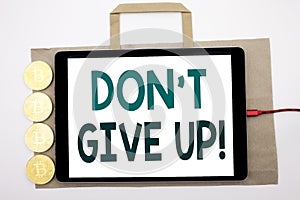 Handwritten text showing Don t Give Up. Business concept writing for Motivation Determination, Written on shopping bag and tablet