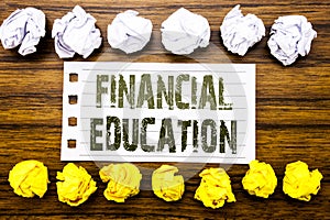 Handwritten text showing Financial Education. Business concept for Finance Knowledge Written on sticky note, wooden with sticky, m photo