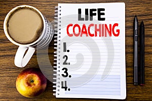 Handwritten text showing Life Coaching. Business concept for Personal Coach Help written on notepad note paper on the wood structu