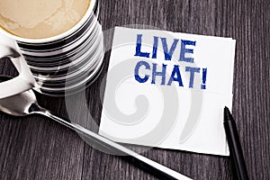 Handwritten text showing Live Chat . Business concept for Communication Livechat written on the tissue paper handkerchief on the w photo