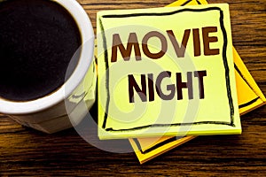 Handwritten text showing Movie Night. Business concept for Wathing Movies written on sticky note paper on the wooden wood backgro
