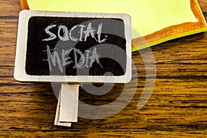 Handwritten text showing Social Media. Business concept for Global Internet Network written on announcement board on the wooden wo