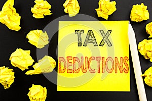 Handwritten text showing Tax Deductions. Business concept writing for Finance Incoming Tax Money Deduction written on sticky note