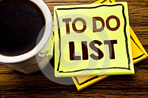 Handwritten text showing To Do List. Business concept for Plan Lists Remider written on sticky note paper on the wooden wood backg photo