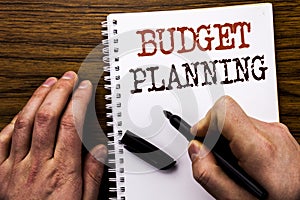 Handwritten text showing word Budget Planning. Business concept for Financial Budgeting Written on tablet laptop, wooden backgroun