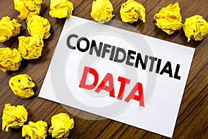 Handwritten text showing word Confidential Data. Business concept writing Secret Protection Written on sticky note paper, wooden b