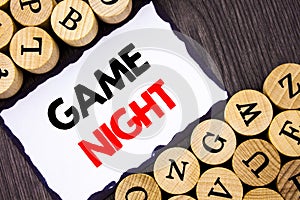 Handwritten text sign showing Game Night. Business concept for Entertainment Fun Play Time Event For Gaming written on White Stick