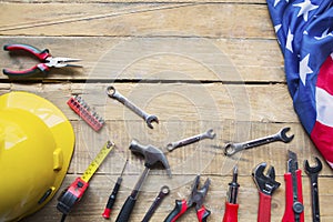 Handy tools and American flag on the wooden table