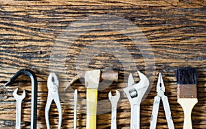 Handy tools on wood background