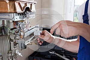 Handyman adjusting gas water heater