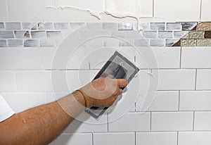 Handyman Applying Ceramic Tile Grout photo