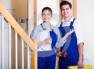 Handyman and assistant in uniform