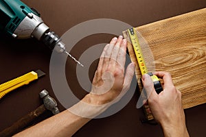 Handyman in blue uniform works with electricity automatic screwdriver.