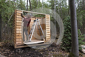 Handyman building a Cedar Storage Shed