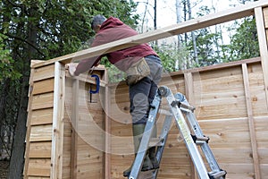 Handyman building a Cedar Storage Shed