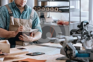 Handyman businessman taking notes photo