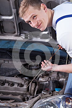 Handyman checking engine oil