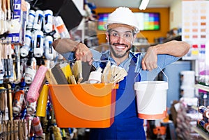 Handyman choosing rollers and varnishes