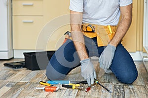 Handyman. Cropped shot of young repairman, professional plumber choosing the best tool for fixing a sink. Tools and