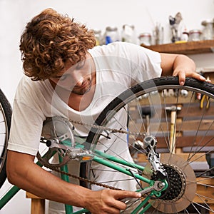 Handyman, fixing and bicycles with with tools at workshop for repair, maintenance with small business. Mechanic