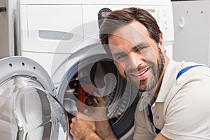 Handyman fixing a washing machine