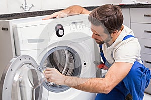 Handyman fixing a washing machine